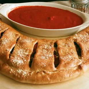 A calzone can be a sharable or personalized. We can add any items on our menu to a calzone.