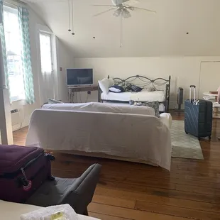 From bed to &quot;living room&quot; showing couch and daybed with trundle. Private entrance to courtyard and balcony on left
