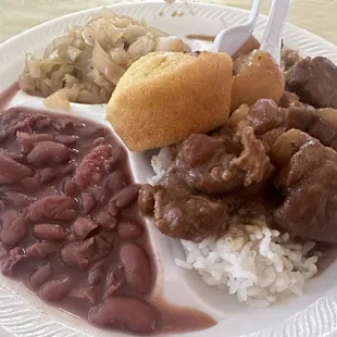 Pork stew over rice, red beans, cabbage, cornbread