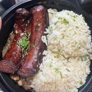 a plate of rice, sausage, and beans