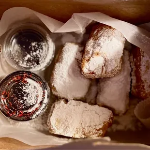 Beignets with berry and chocolate sauces
