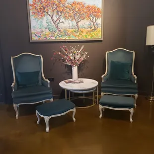 a living room with chairs and a table