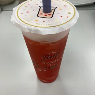 Strawberry fruit tea with strawberry popping bubbles.