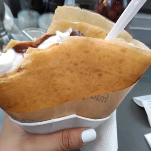 a person holding a hot dog