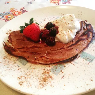 a crepe with whipped cream and berries