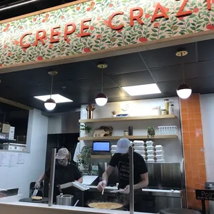 two people preparing food in a restaurant