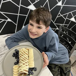 Wrapped Crepe with White Chocolate, Banana and Blue Berries.