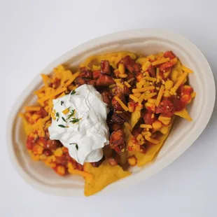 a plate of nachos with sour cream