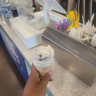 a person holding an ice cream cone