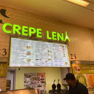 a menu and a man at the counter