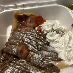  a chocolate crepe with whipped cream and strawberries