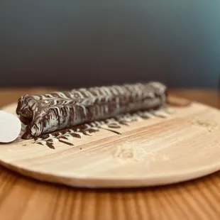 a chocolate dessert on a wooden plate