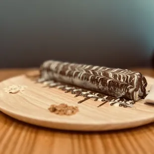 a chocolate dessert on a wooden plate
