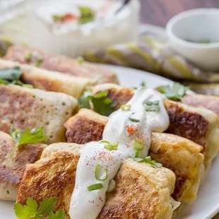 American Beef Crepe: All-American style beef hash crepe with corned beef hash, cheddar cheese, corn, egg, and sour cream.