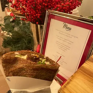 a table with a menu and flowers