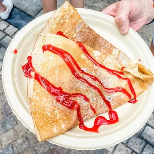 a person holding a plate of food