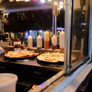 two pizzas on a cart
