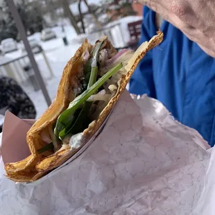 a person holding a sandwich