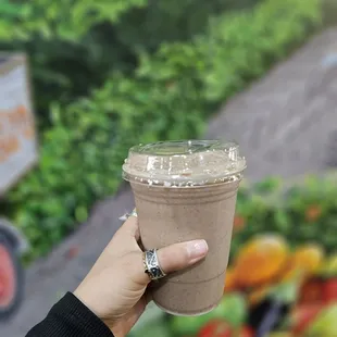 a hand holding a cup of coffee
