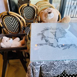 a teddy bear sitting in a high chair