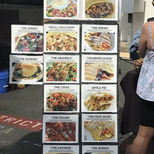 a woman standing in front of a display of food