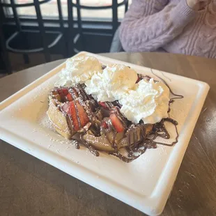 Waffle with strawberries, Nutella, and whipped cream
