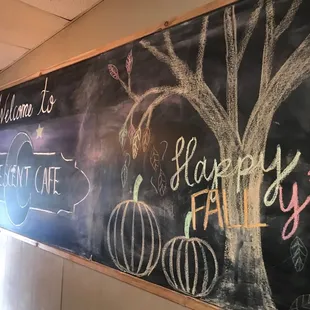 a chalk board with a happy fall sign