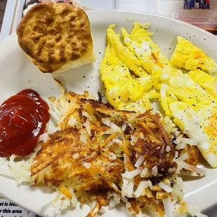 Scrambled eggs, hash browns, biscuit