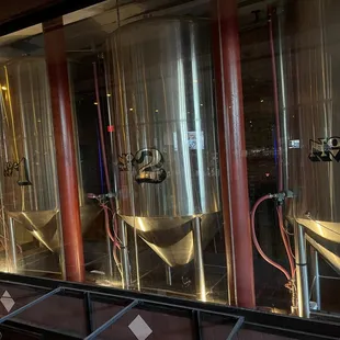 a row of stainless steel tanks