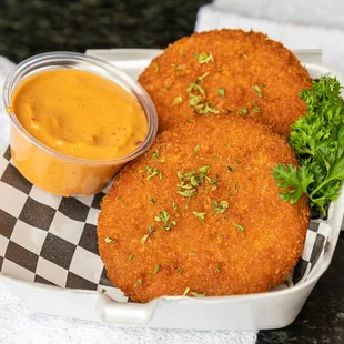 a fried chicken cutlet with a side of sauce