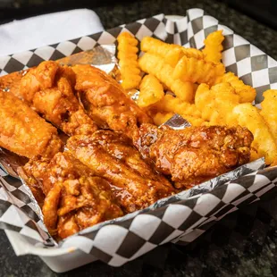 a basket of chicken wings and fries