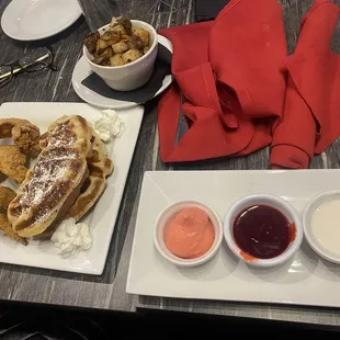 Croffle with wings and a side of breakfast potatoes