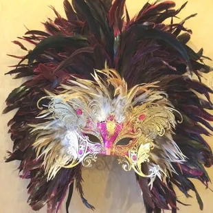 Our feathered masks are all hand made and hand paint in our galley in front of our customers!
