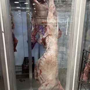 a meat display in a glass case