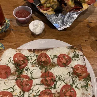 Margherita flatbread and pulled pork nachos.