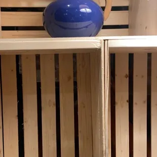 a cup of cappuccino on a wooden shelf