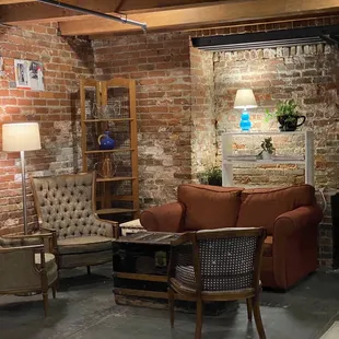 a living room with brick walls