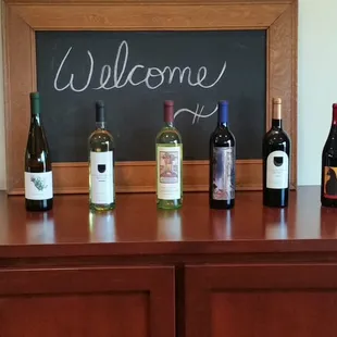 a selection of wines on a bar