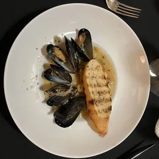 Steamed PEI Mussels  Roasted potatoes, nduja, local sweet pep, chicken stock, white wine, butter, garlic, shallots and garlic bread