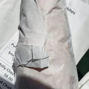 a sandwich wrapped in paper