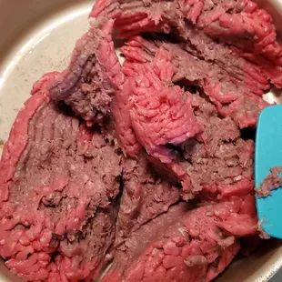 meat in a pan with a spatula