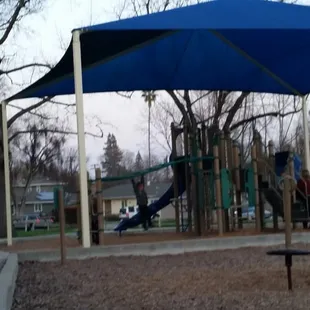 Play area with shade canopy for those hot summer days!
