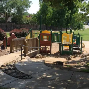 Follow the sidewalk past the restroom and you'll find it. It's not easily spotted from the street.