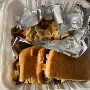 a sandwich and coleslaw in a styrofoam container