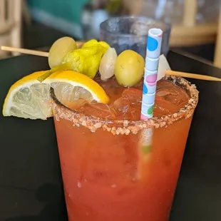 a bloody drink with lemons and a straw