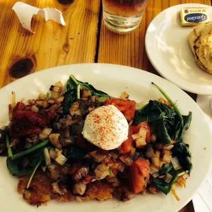 Skillet Potatoes, with spinach, tomatoes, cheese, and sour cream. Served with a homemade biscuit.