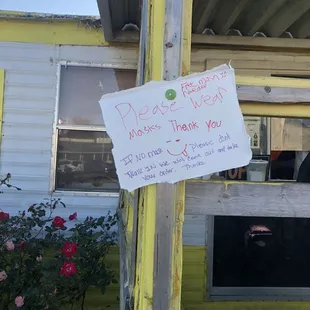 a sign on the porch of a mobile home