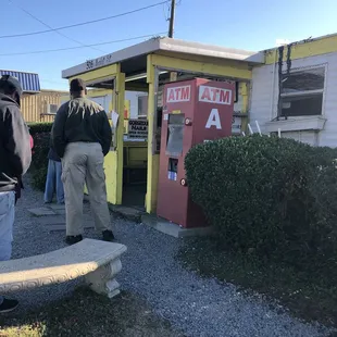 a man and a woman standing outside of a restaurant