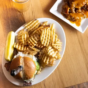 1/2 lb Burger topped with bacon * shredded cheddar and mozzarella cheeses * Crickets sauce* BBQ sauce * caramelized onions