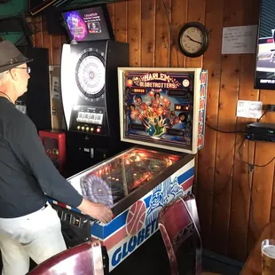 a man playing a pinball game